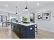 Bright kitchen boasts a large center island with dark blue cabinetry and pendant lighting at 562 Scholar Way, Summerville, SC 29486