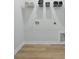 The laundry room offers plenty of storage space and new wood laminate floors at 562 Scholar Way, Summerville, SC 29486