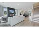 Bright living room features modern fireplace, large windows, and open layout flowing into the kitchen at 562 Scholar Way, Summerville, SC 29486