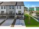 Rear exterior view of new townhomes with balconies and a blue handicap parking space at 562 Scholar Way, Summerville, SC 29486