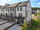 Exterior rear view of new townhomes boasting balconies, and accessible parking at 562 Scholar Way, Summerville, SC 29486