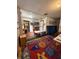 Bright room with colorful rug, tables, chairs, and educational decorations on walls, with connecting room at 715 Yew St, Charleston, SC 29407