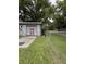 Exterior shot of garage with red door and chainlink fence on a grassy area at 715 Yew St, Charleston, SC 29407
