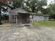 Quaint gray home featuring a covered porch and a small front yard with mature trees at 715 Yew St, Charleston, SC 29407