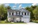 Charming two-story home featuring a symmetrical design, light blue siding and black shutters at 78 French Garden Cir, Summerville, SC 29486