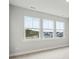 Bright, light-filled empty room with neutral walls and carpet, featuring many large windows at 78 French Garden Cir, Summerville, SC 29486