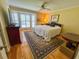 Bedroom featuring hardwood floors, a large window, and a ceiling fan at 946 Law Ln, Mount Pleasant, SC 29464
