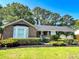Charming brick home with manicured landscaping, a welcoming front porch, and an attached two-car garage at 946 Law Ln, Mount Pleasant, SC 29464