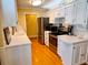 Bright kitchen featuring white cabinets, stainless steel appliances, and hardwood floors at 946 Law Ln, Mount Pleasant, SC 29464