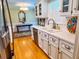 Well-lit kitchen featuring white cabinetry, stainless steel dishwasher, and a view into the dining area at 946 Law Ln, Mount Pleasant, SC 29464