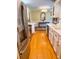 Galley kitchen featuring white cabinets, stainless steel appliances, and hardwood floors at 946 Law Ln, Mount Pleasant, SC 29464