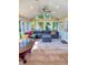 Sunroom filled with natural light, featuring a large sectional sofa and comfortable seating area with a fan and tile floor at 946 Law Ln, Mount Pleasant, SC 29464