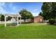 Expansive backyard featuring a swing, mature trees, well-kept lawn and white picket fence at 101 Barberry St, Summerville, SC 29483