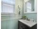 Cozy powder room features a dark vanity, decorative mirror, and bright natural light at 101 Barberry St, Summerville, SC 29483