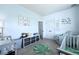 Spacious Bedroom with two cribs, a comfortable glider, and themed decor, creating a welcoming atmosphere at 101 Barberry St, Summerville, SC 29483