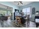 Cozy dining room with a view of the living room, modern light fixtures, and wood floors at 101 Barberry St, Summerville, SC 29483