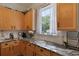 Bright kitchen with granite countertops, wooden cabinets, and a window over the sink at 101 Barberry St, Summerville, SC 29483