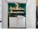 Well-organized laundry room with modern washer and dryer, ample storage shelves, and bright teal walls at 101 Barberry St, Summerville, SC 29483