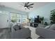 Bright living room with lots of natural light, gray sofa, and a modern ceiling fan at 101 Barberry St, Summerville, SC 29483