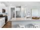 Modern kitchen with white cabinets, stainless steel appliances, a spacious island, and elegant countertops at 1033 Tea Time Dr, Summerville, SC 29485