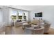 Bright living room with large windows, a comfortable white sofa, stylish armchairs, and modern decor at 1033 Tea Time Dr, Summerville, SC 29485