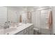 Well-lit bathroom featuring a double sink vanity and shower with a shower curtain at 1034 Scotch Bonnet Way, Summerville, SC 29485
