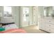 Cozy bedroom with a plush bed, white dresser, and view of backyard trees at 1034 Scotch Bonnet Way, Summerville, SC 29485