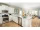 Bright kitchen featuring granite countertops, stainless steel appliances, and white cabinets at 1034 Scotch Bonnet Way, Summerville, SC 29485