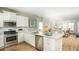 Bright kitchen featuring granite countertops, stainless steel appliances, and white cabinets at 1034 Scotch Bonnet Way, Summerville, SC 29485