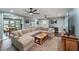 Spacious living room featuring a plush sectional, ceiling fans, and hardwood flooring at 1039 Grand Concourse St, Charleston, SC 29412