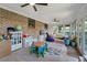 Bright playroom featuring large windows, ceiling fans, brick wall, and plenty of space to play at 1039 Grand Concourse St, Charleston, SC 29412