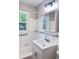 Bright bathroom featuring a white vanity, updated lighting, accessible grab bars, and a window at 105 Dandridge Rd, Walterboro, SC 29488