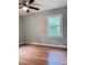 Bedroom featuring hardwood floors, neutral paint, a ceiling fan, and a window offering natural light at 105 Dandridge Rd, Walterboro, SC 29488