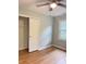 Bedroom showcasing hardwood floors, a closet with sliding doors, a window, and a ceiling fan at 105 Dandridge Rd, Walterboro, SC 29488