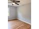 Cozy bedroom features hardwood floors, a ceiling fan, and a window with a pleasant view at 105 Dandridge Rd, Walterboro, SC 29488