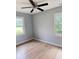 Bedroom highlighting hardwood floors, neutral paint, two windows, and a ceiling fan at 105 Dandridge Rd, Walterboro, SC 29488