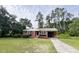 Charming brick house with an attached carport, nicely landscaped lawn and an inviting facade at 105 Dandridge Rd, Walterboro, SC 29488