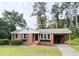 Charming brick house with an attached carport, nicely landscaped lawn and an inviting facade at 105 Dandridge Rd, Walterboro, SC 29488