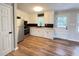 Updated kitchen has white cabinets, stainless steel appliances, and wood floors at 105 Dandridge Rd, Walterboro, SC 29488