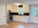 Kitchen features white cabinets, stainless steel appliances, and butcher block counters at 105 Dandridge Rd, Walterboro, SC 29488
