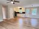 Open-concept living space featuring gleaming hardwood floors, ceiling fan and combined living and kitchen area at 105 Dandridge Rd, Walterboro, SC 29488