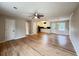Open-concept living space featuring gleaming hardwood floors, ceiling fan and combined living and kitchen area at 105 Dandridge Rd, Walterboro, SC 29488