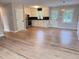 Open-concept living space featuring gleaming hardwood floors, ceiling fan and combined living and kitchen area at 105 Dandridge Rd, Walterboro, SC 29488