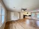 Open-concept living space featuring gleaming hardwood floors, ceiling fan and combined living and kitchen area at 105 Dandridge Rd, Walterboro, SC 29488