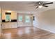 Bright living room open to kitchen features hardwood floors, ceiling fan, and light neutral paint at 105 Dandridge Rd, Walterboro, SC 29488