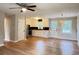 Open-concept living space featuring gleaming hardwood floors, ceiling fan and combined living and kitchen area at 105 Dandridge Rd, Walterboro, SC 29488
