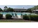 A community pool with chairs around it and a building that has a tin roof in the background at 107 Brookhaven Rd, Summerville, SC 29486