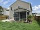 Exterior of a house with a screened-in porch, patio, and grassy backyard at 107 Brookhaven Rd, Summerville, SC 29486