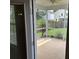 View of a covered and screened-in porch with a ceiling fan, and view of fenced yard at 107 Brookhaven Rd, Summerville, SC 29486