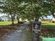 Walking trail between the houses and trees with an Old Rice Retreat sign at 107 Brookhaven Rd, Summerville, SC 29486